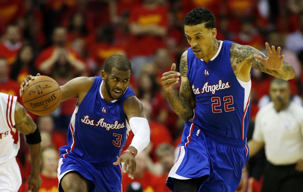 Chris Paul controls the ball as Clippers teammate Matt Barnes backs out of the way.