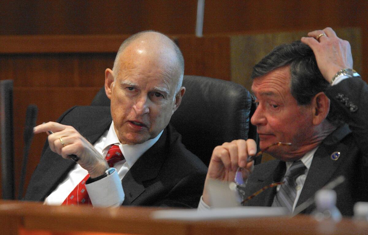 In January 2013, Gov. Jerry Brown and Cal State Chancellor Timothy P. White talk during a meeting of the university system's board.