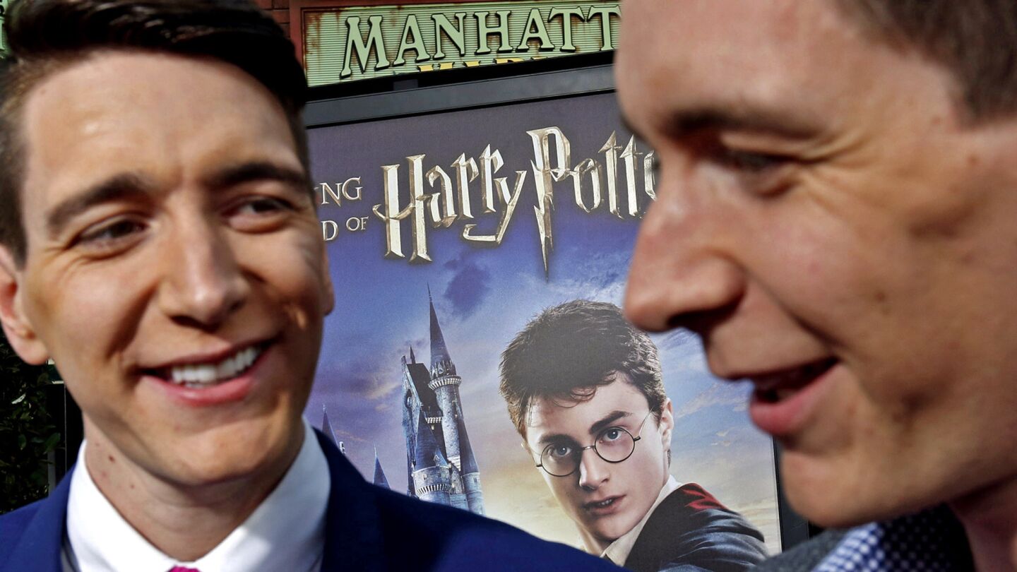 Actors Oliver, left, and James Phelps, who played the Weasley brothers in the Harry Potter films, at the Wizarding World of Harry Potter debut at Universal Studios Hollywood.