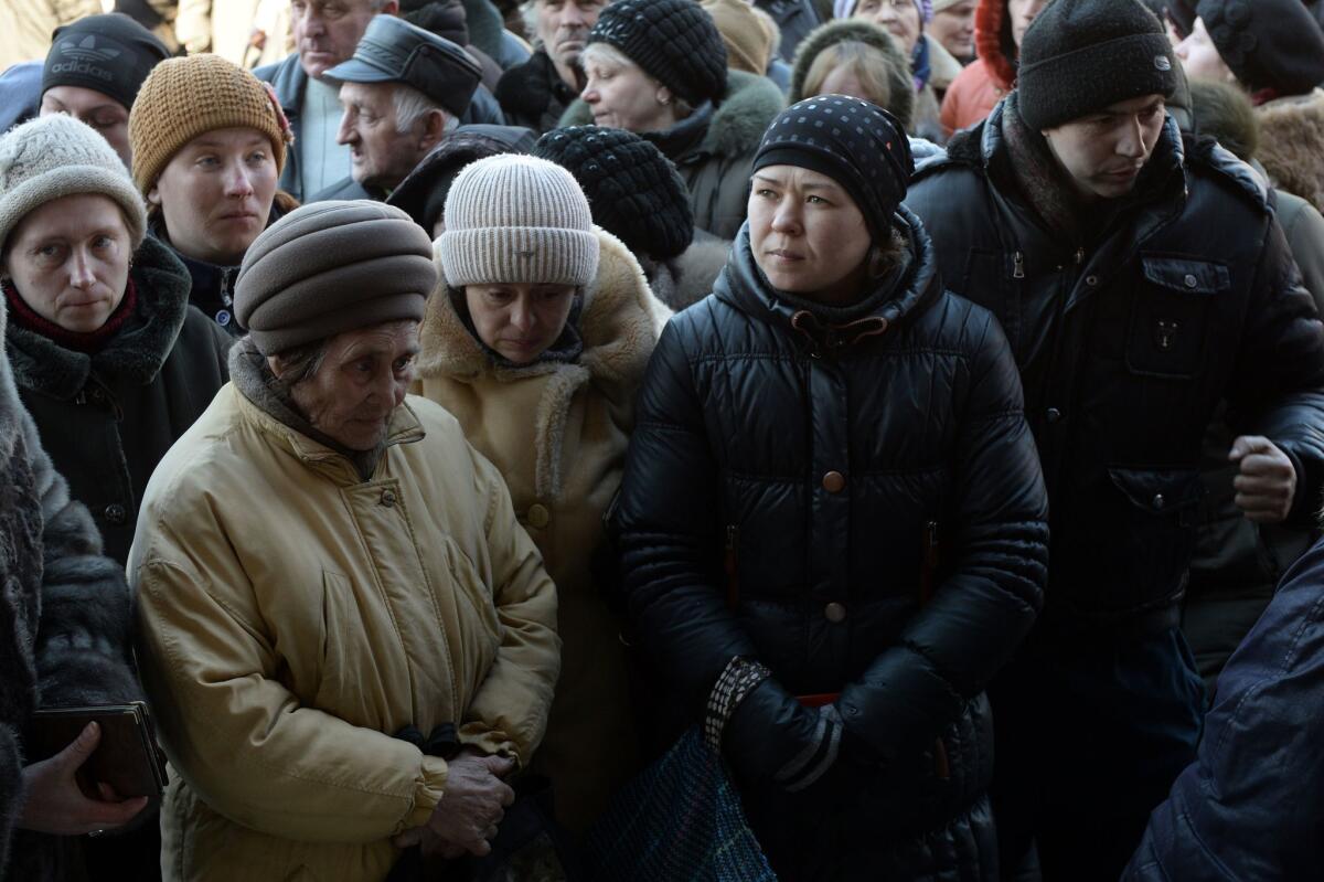Local residents wait in line for humanitarian aid in the eastern Ukrainian city of Debaltseve in the Donetsk region, on Sunday.