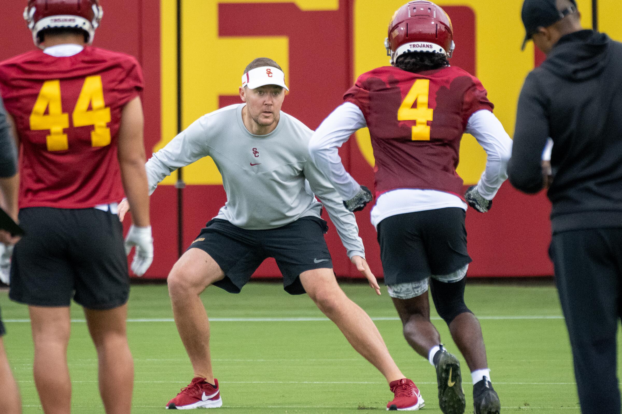 USC coach Lincoln Riley works with receiver Mario Williams during a training camp practice session.