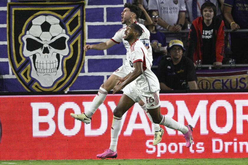 Toronto FC midfielder Jonathan Osorio, rear, celebrates with forward Tyrese Spicer (16) after Spicer's goal against Orlando City during the second half of an MLS soccer match Saturday, April 27, 2024, in Orlando, Fla. (AP Photo/Phelan M. Ebenhack)