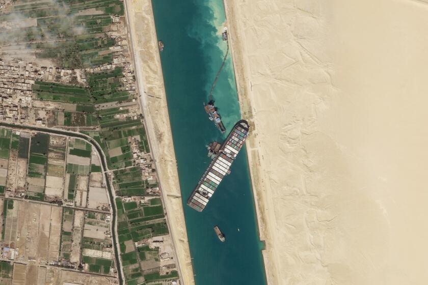 FILE - In this March 28, 2021, satellite file image from Planet Labs Inc, the cargo ship MV Ever Given sits stuck in the Suez Canal near Suez, Egypt. Consumers may face shortages and higher prices for electronics, toys, furniture and other goods should attempts to free the mammoth container ship stuck in Egypt’s Suez Canal drag on several weeks. (Planet Labs Inc. via AP)