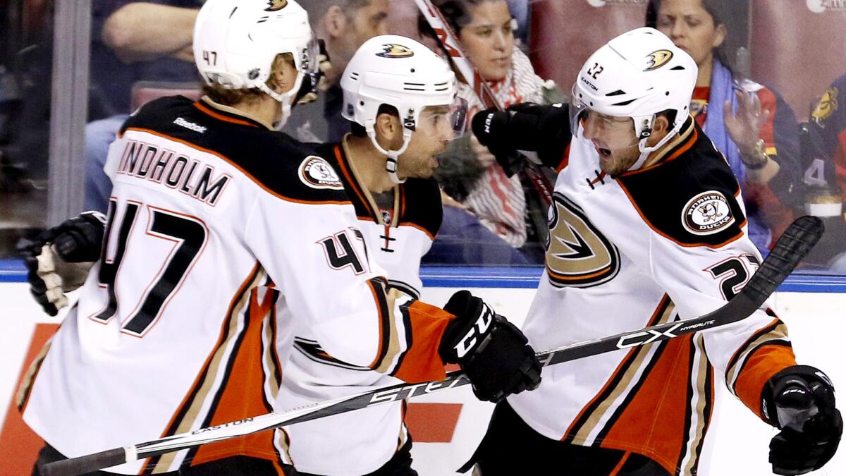 Ducks center Andrew Cogliano, center, is congratulated by teammates Hampus Lindholm and Shawn Horcoff after his third-period goal against the Panthers on Thursday.