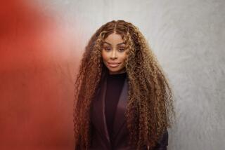 Blac Chyna, with long curly hair, poses in a dark suit for a portrait on Thursday, Jan. 18, 2024 in El Segundo, CA 