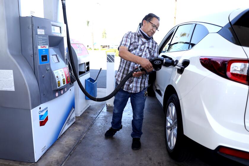 ORANGE, CA - MARCH 08: Juan Galaiviz, of Santa Ana pumps gas into his automobile at the Chevron gas station along Katella Ave. and Glassell on Tuesday, March 8, 2022 in Orange, CA. Galaiviz paid $50.00 for 8.866 gallons of regular gasoline. Juan drove from Santa Ana because it was less expensive in Orange. The average price of a gallon of self-serve regular gasoline in Los Angeles County rose 8.9 cents today, its 30th record in 32 days. In Orange County average price rose 8.8 cents, its 29th record in 34 days. (Gary Coronado / Los Angeles Times)