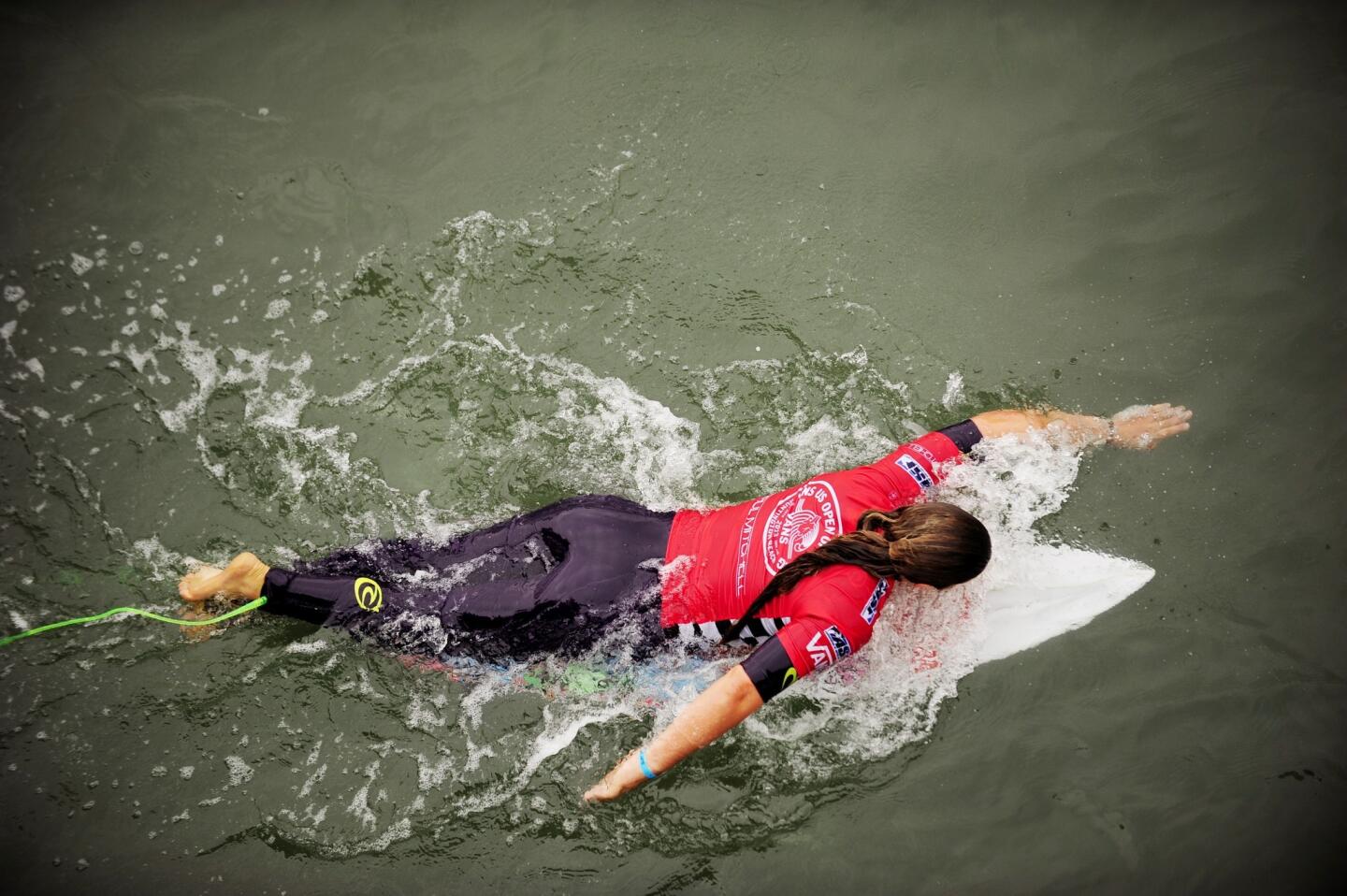 Tyler Wright paddles for a wave