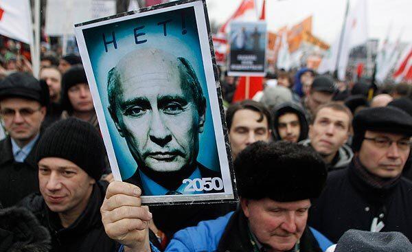 A demonstrator in Moscow holds a poster showing an artificially aged image of Russian Prime Minister Vladimir Putin and bearing the words "No! 2050" during a mass rally to protest against alleged vote rigging in Russia's parliamentary elections. Tens of thousands of people held the largest antigovernment protests that post-Soviet Russia has seen to criticize the alleged electoral fraud and demand an end to Vladimir Putin's rule.