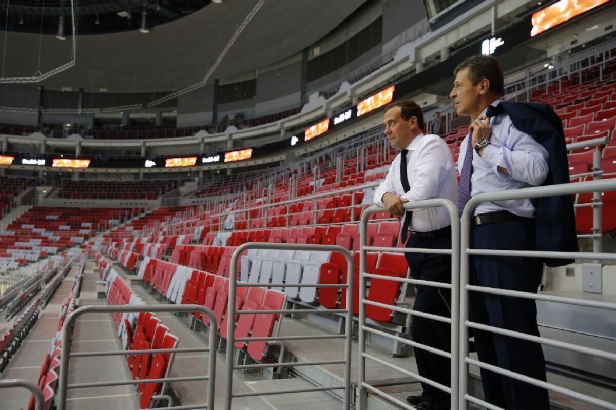 Russian Prime Minister Dmitry Medvedev, left, and Deputy Prime Minister Dmitry Kozak take in the view from the stands of the Bolshoy Ice Dome, a venue for the 2014 Winter Olympics, during a visit to Sochi.