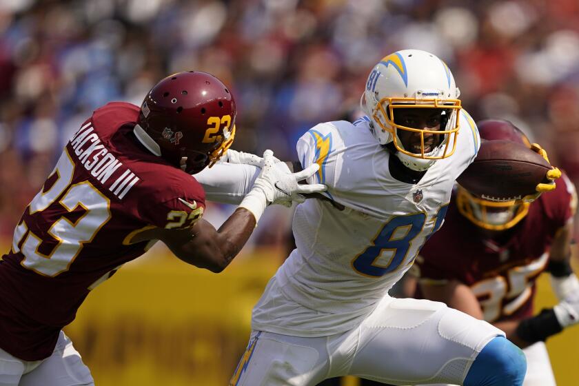 Los Angeles Chargers wide receiver Mike Williams (81) breaks away from Washington Football Team cornerback William Jackson (23) during the first half of an NFL football game, Sunday, Sept. 12, 2021, in Landover, Md. (AP Photo/Andrew Harnik)