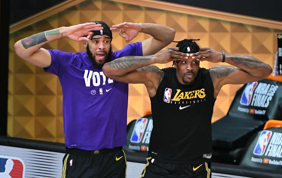Lakers centers JaVale McGee, left, and Dwight Howard watch the Lakers head toward a Game 6 win and NBA title.