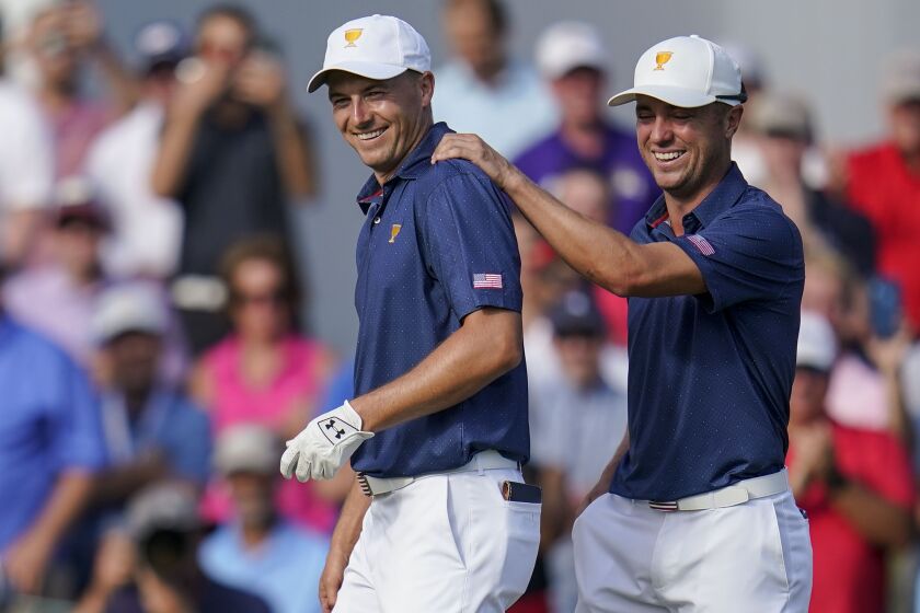 Jordan Spieth, left, and Justin Thomas celebrate winning the match on the 15th hole during their fourball match at the Presidents Cup golf tournament at the Quail Hollow Club, Saturday, Sept. 24, 2022, in Charlotte, N.C. (AP Photo/Julio Cortez)