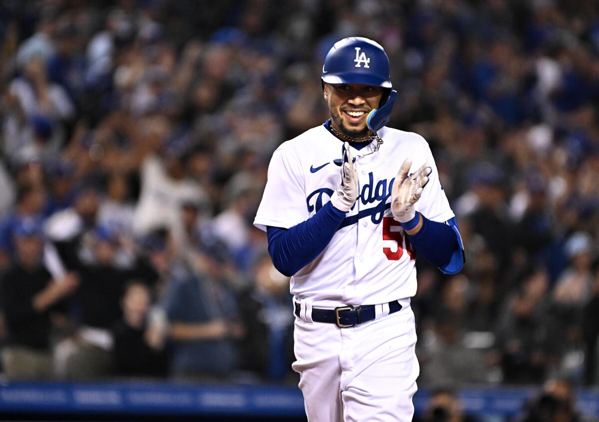 Mookie Betts claps and smiles during a Dodgers game.