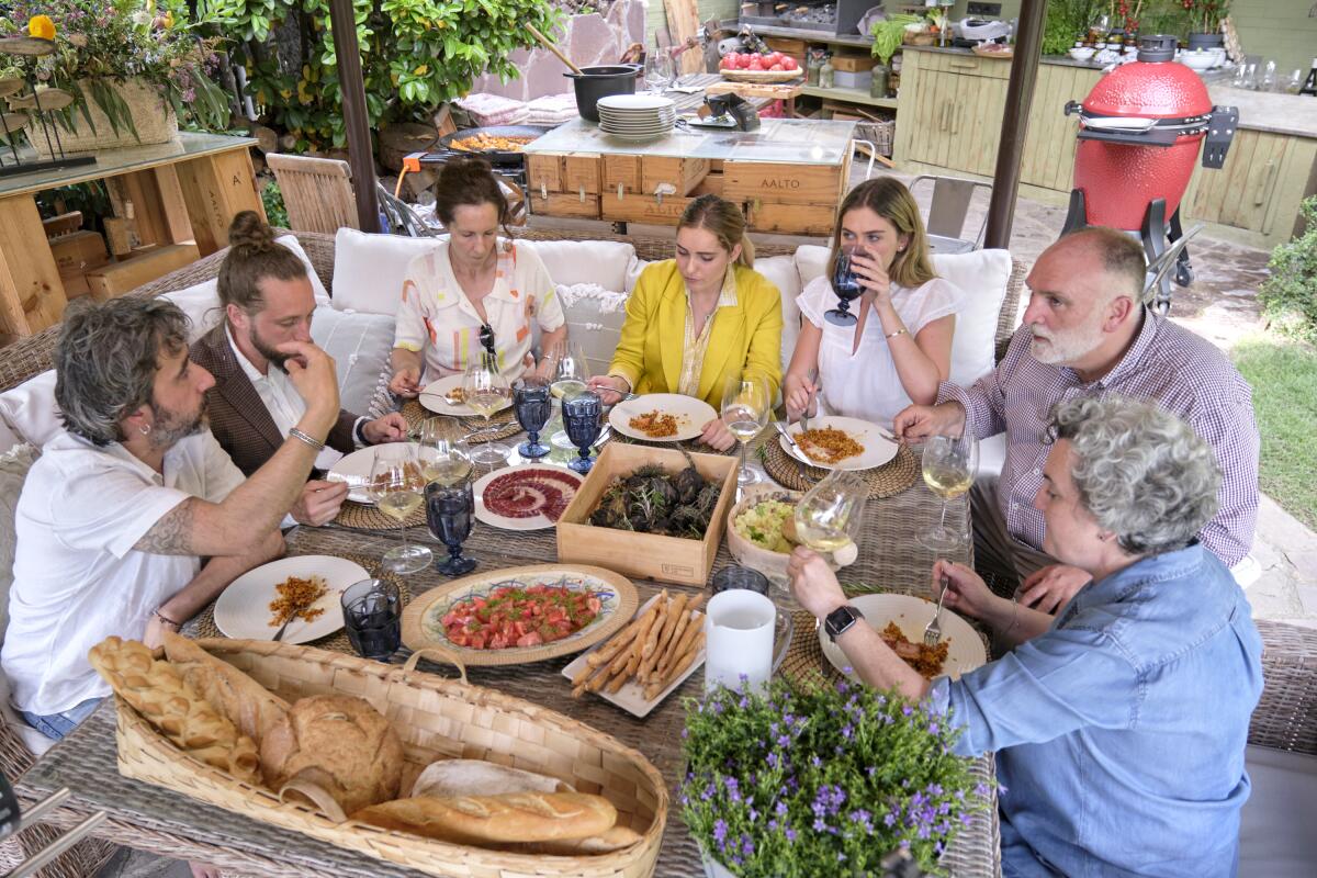 A group of people feast around an outdoor table in Spain