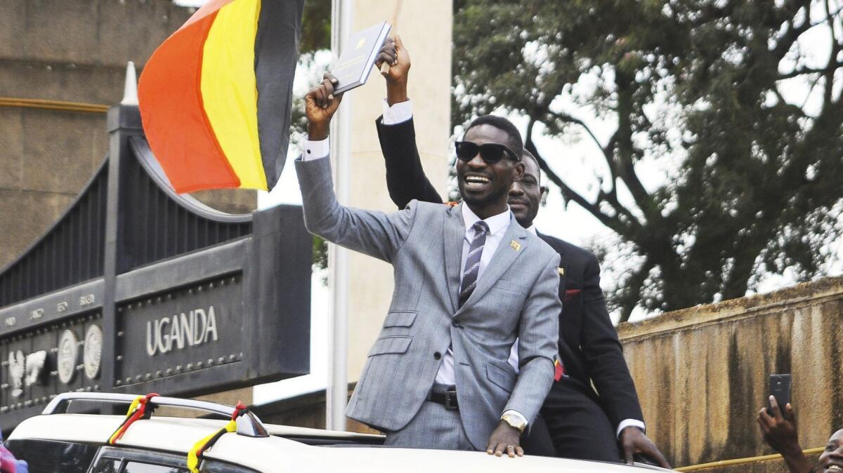 Ugandan pop star Kyagulanyi Ssentamu, better known as Bobi Wine, greets supporters shortly after being sworn in as a member of Parliament in Kampala, Uganda.
