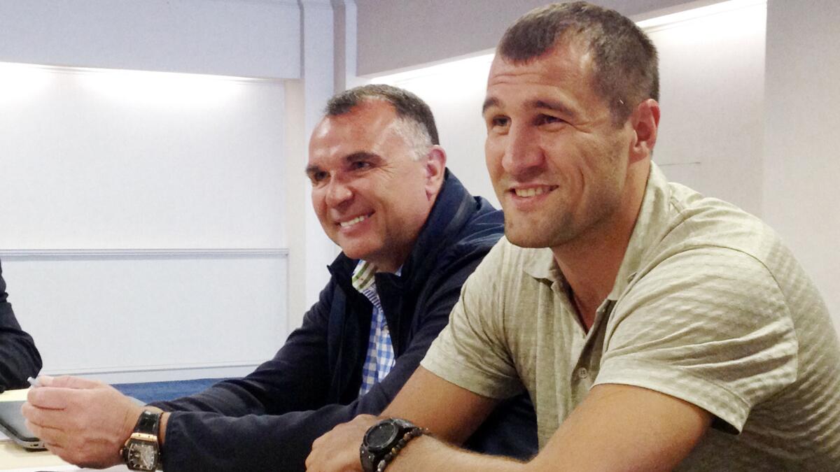 Manager Egis Klimas, left, and boxer Sergey Kovalev talk to reporters on April 23.