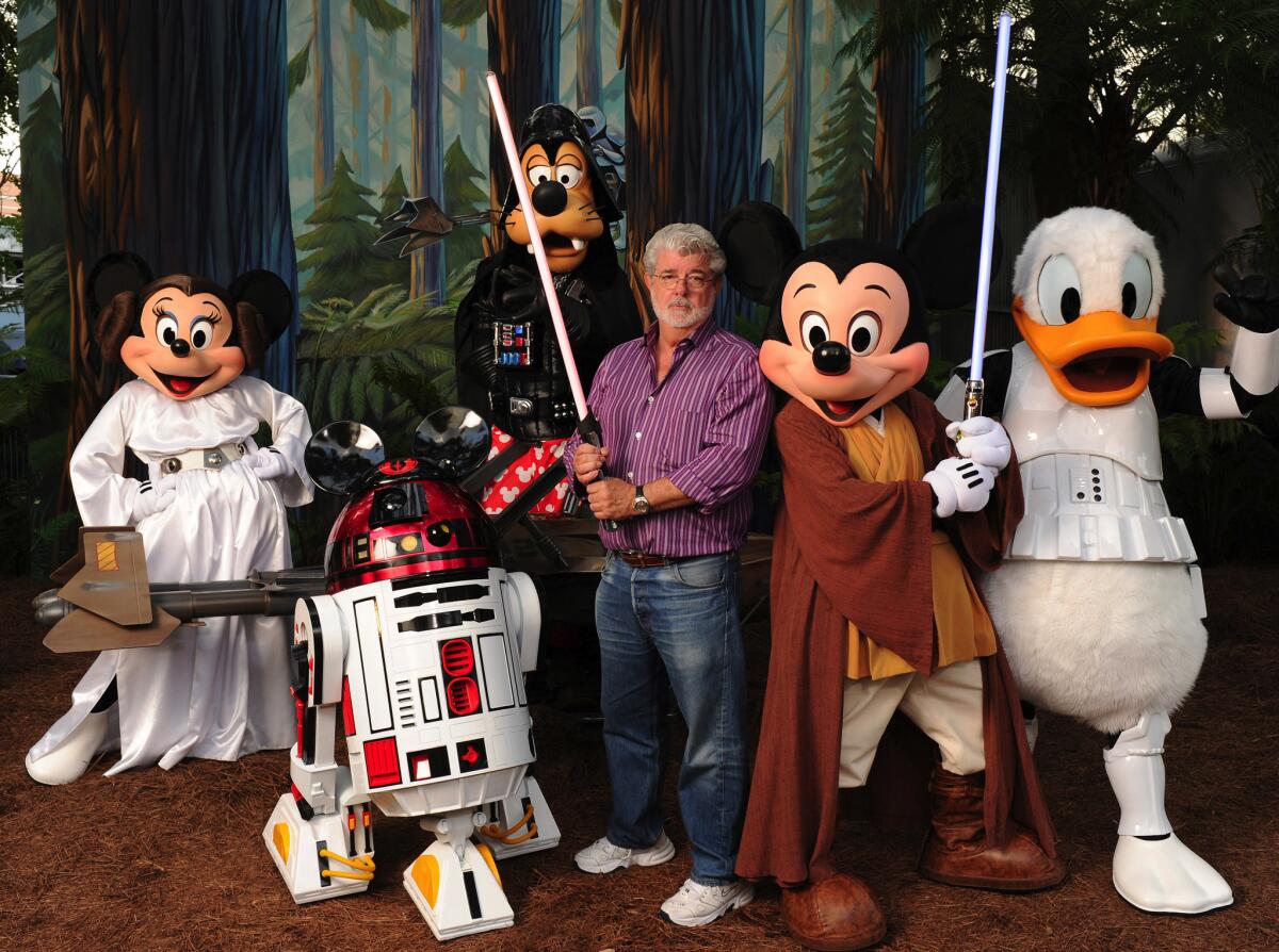 "Star Wars" creator and filmmaker George Lucas poses with a group of "Star Wars"-inspired Disney characters on Aug. 14, 2010 at Disney's Hollywood Studios theme park in Florida.