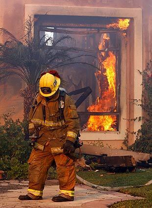 Orange County fires - Firefighter hangs his head
