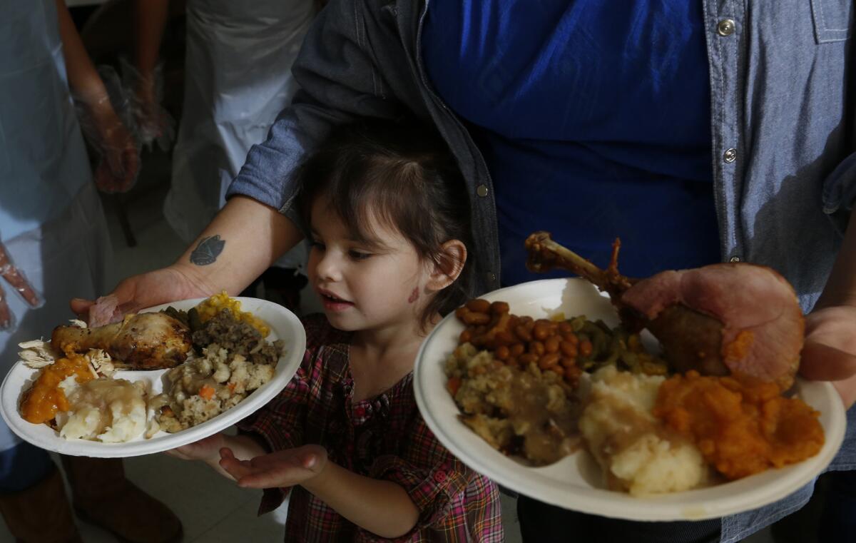 Tanya Le Flore, 36, with daughter Olia Le Flore, 2, of Long Beach at the United American Indian Involvement meal.