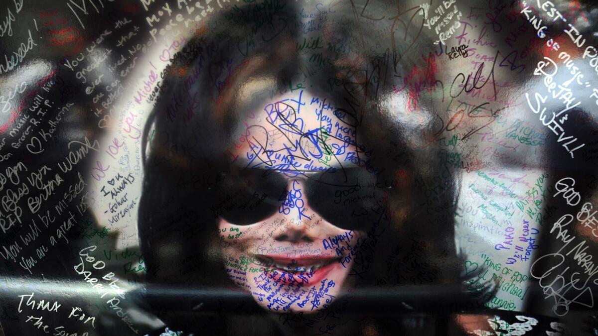 A poster of Michael Jackson is signed by fans near his star on Hollywood Boulevard on June 29, 2009.