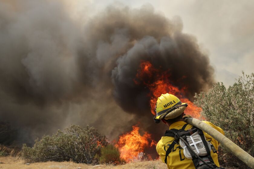 Hemet, CA - September 07: A firefighter attacks on brush fire on third day of Fairview Fire along in Bautista Canyon Road on Wednesday, Sept. 7, 2022 in Hemet, CA. (Irfan Khan / Los Angeles Times)