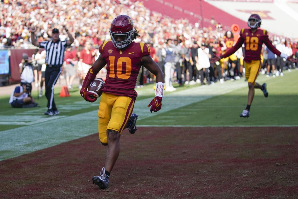 USC linebacker Ralen Goforth scores on an interception return during the second half against Rice.