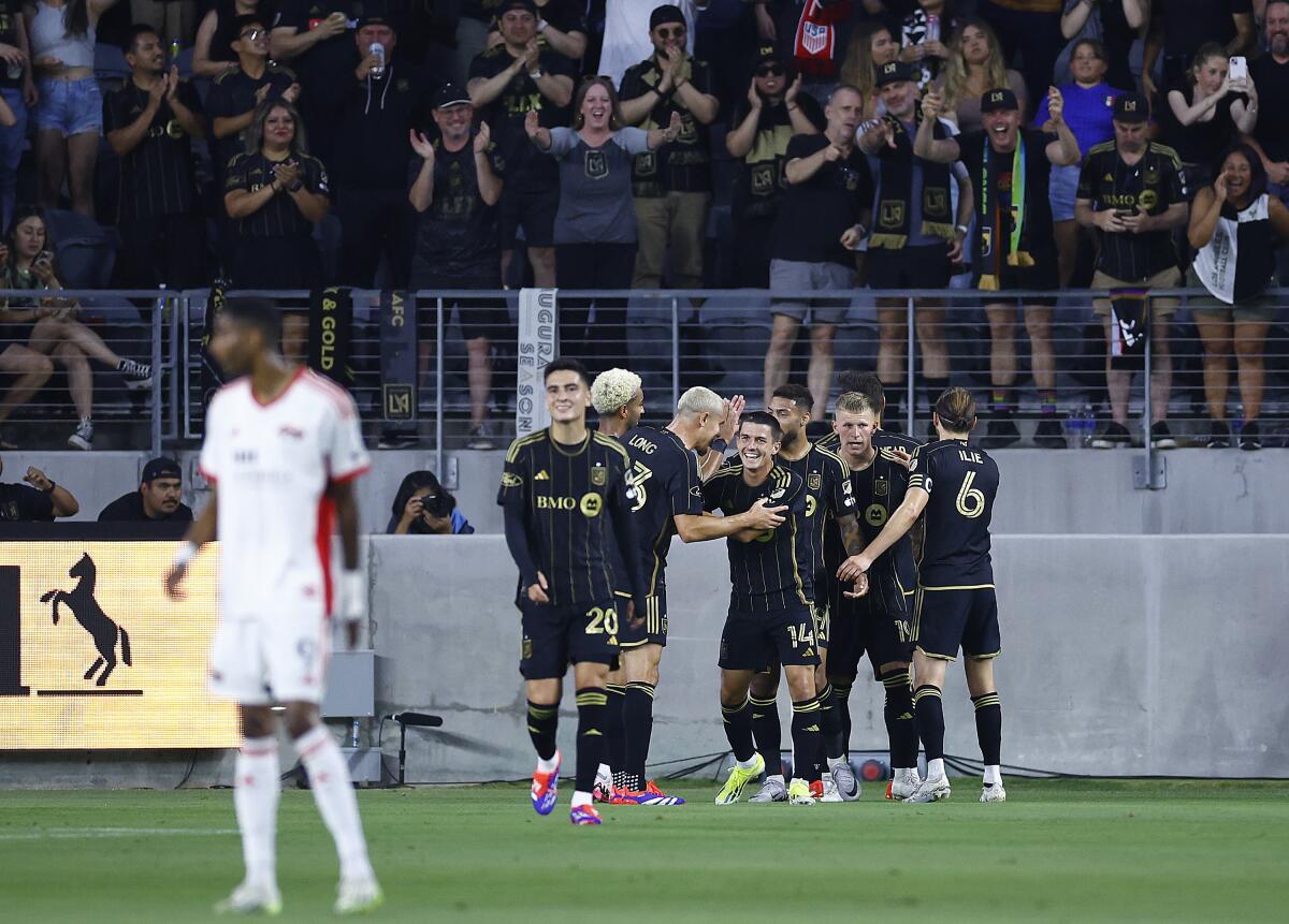 LAFC players celebrate after a goal  during the first half of a 6-2 victory over the San José Earthquakes.