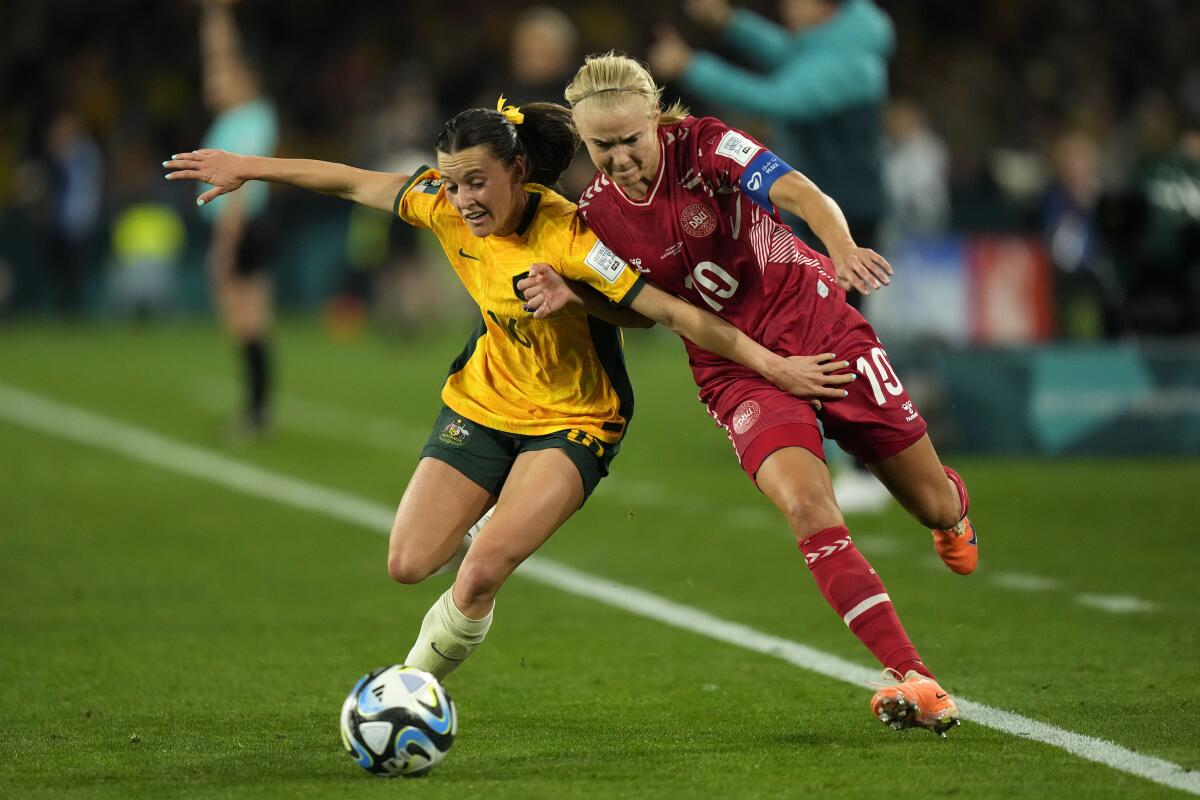 Australia's Hayley Raso, left, tries to fend off Denmark's Pernille Harder during a Women's World Cup match on Aug. 7.