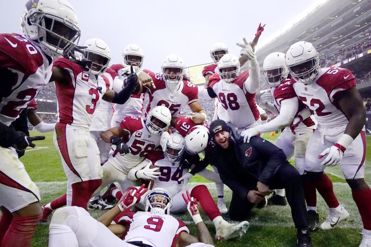 The Arizona Cardinals celebrates around defensive end Zach Allen after Allen's pass of Chicago Bears quarterback Andy Dalton during the second half of an NFL football game Sunday, Dec. 5, 2021, in Chicago. The Cardinals won 33-22. (AP Photo/David Banks)