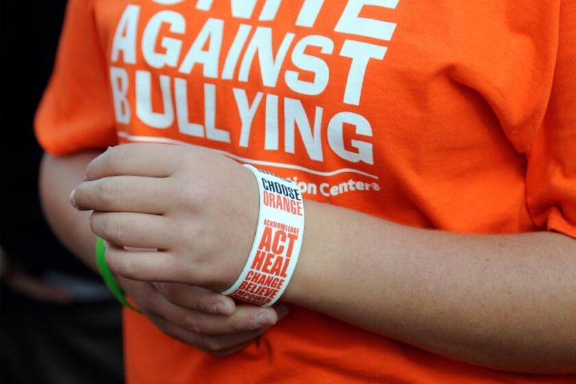 A student in Blue Earth, Minn., wears a T-shirt and wristband in support of National Bullying Prevention Month.