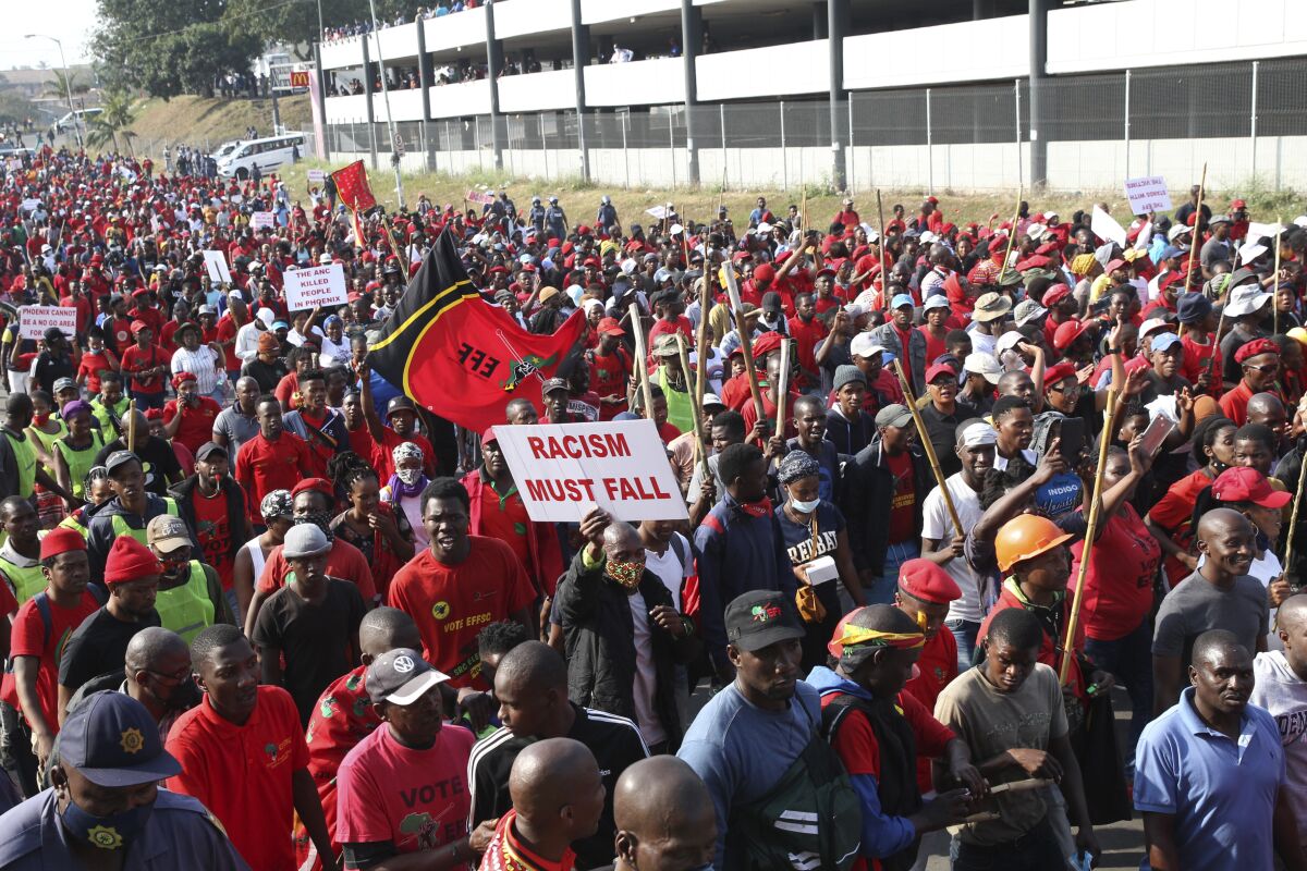 Supporters of South Africa's leftist opposition party, the Economic Freedom Fighters, gather, in Phoenix, South Africa, Thursday, Aug. 5, 2021, during a demonstration against the killings of 36 people in Phoenix, during the recent violent riots in KwaZulu-Natal province. More than 1,000 people marched through Phoenix to hand police a statement demanding justice for the families of those who were killed in that town during the violence. (AP Photo)