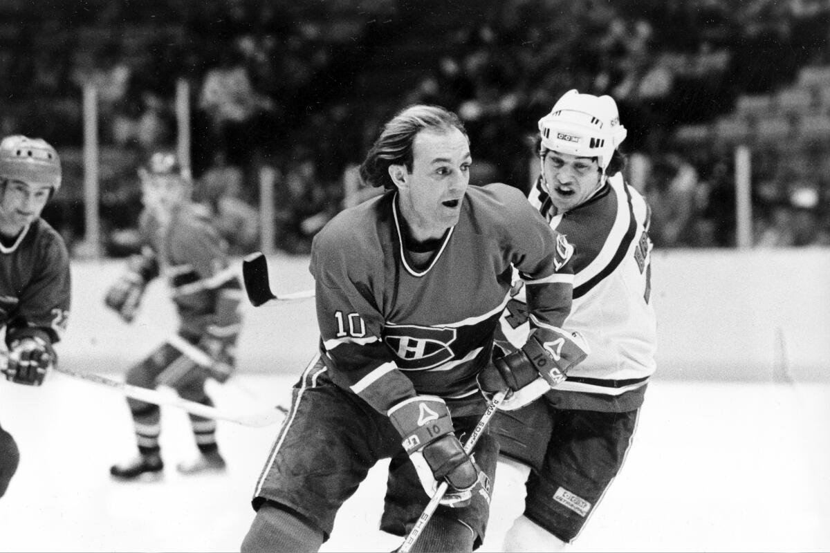 Montreal Canadiens forward Guy Lafleur cuts in front of New Jersey Devils forward Aaron Broten.