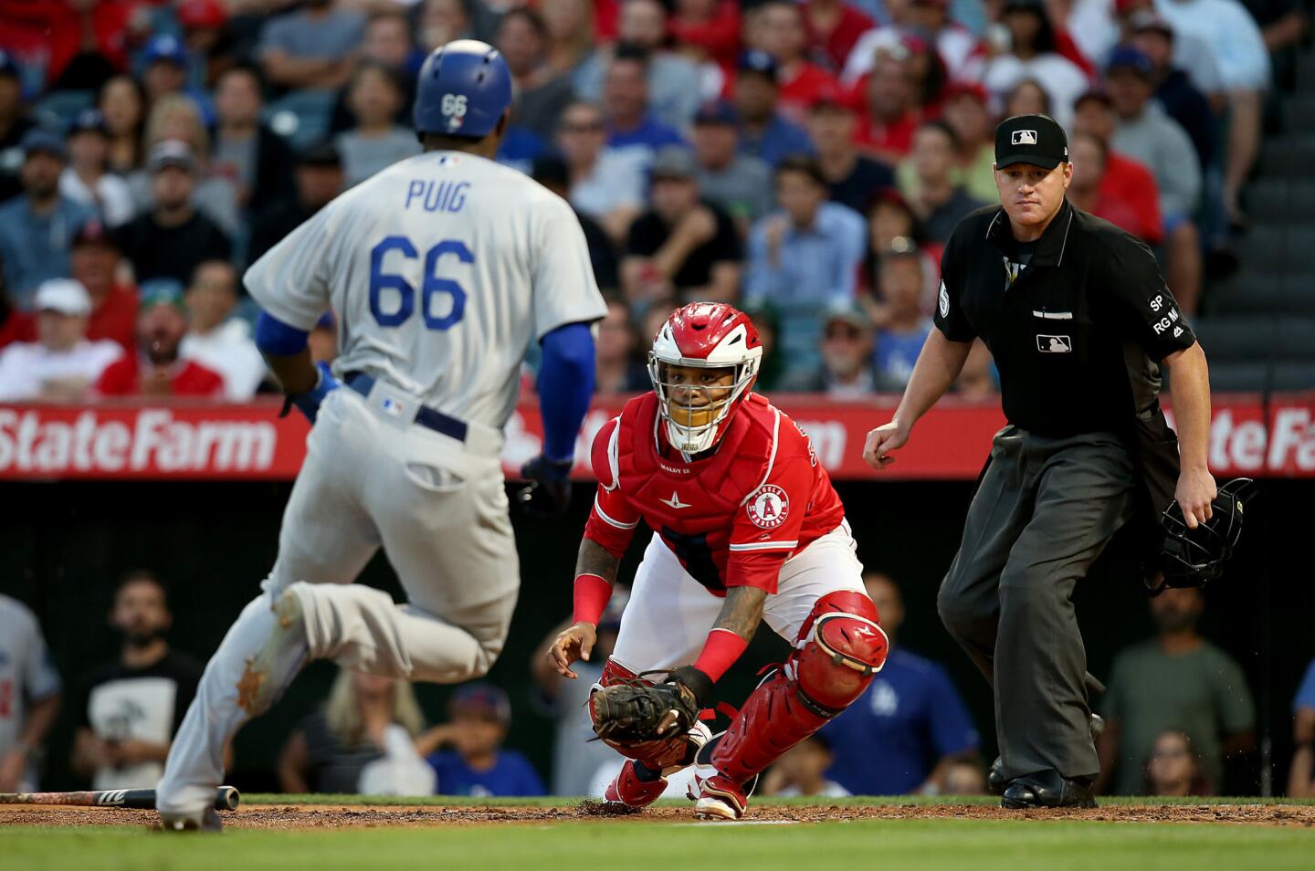 Angels catcher Martin Maldonado prepares to put a tag on Dodgers right fielder Yasiel Puig in the third inning.