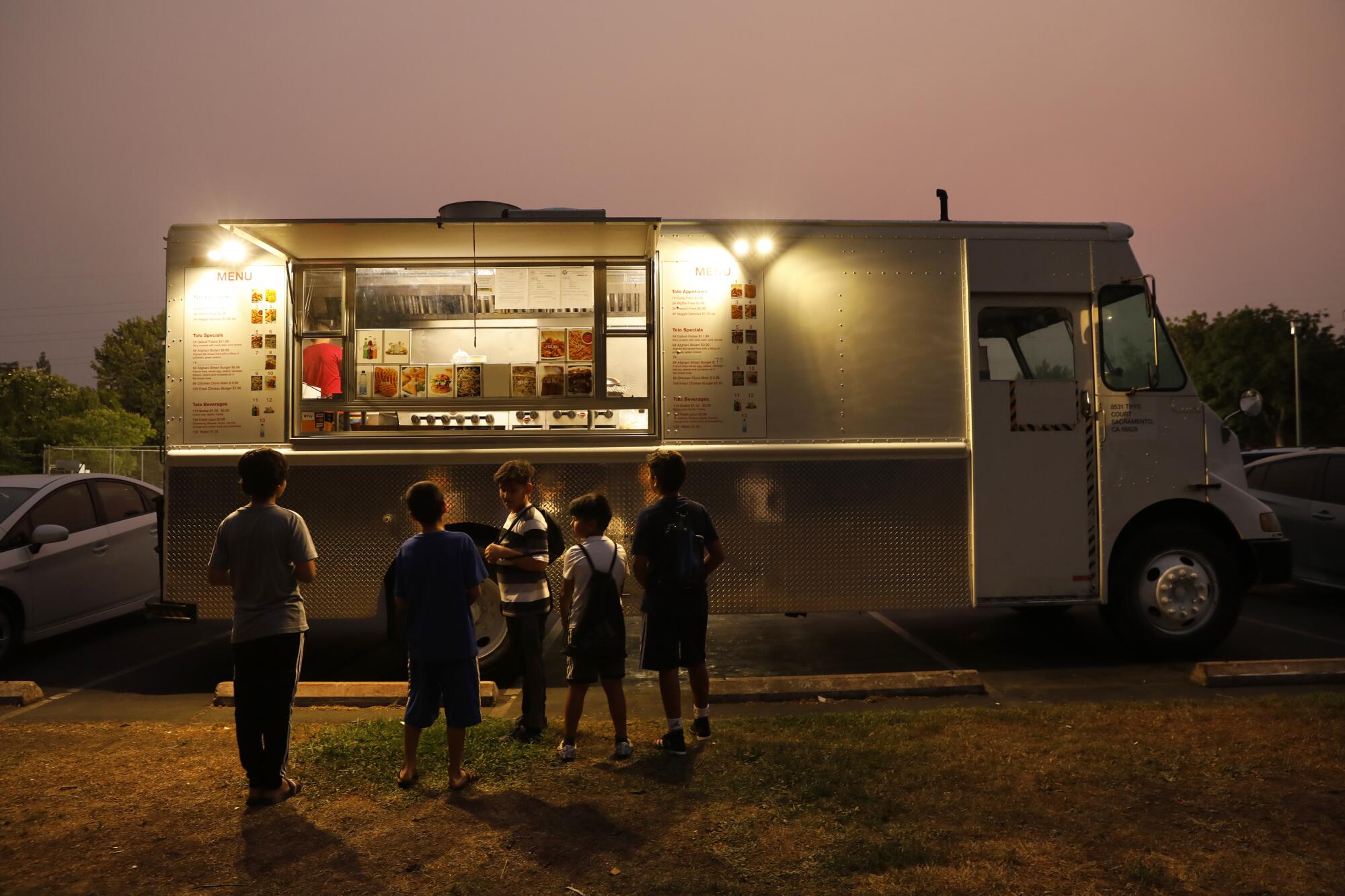 Children gathered at a food truck