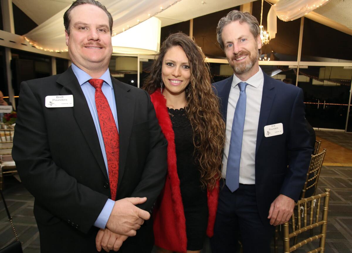 La Cañada Rose float supporters Brett Pounders, left, Poliana Sicchieri and Eric Pounders, at the La Cañada Flintridge Tournament of Roses Assn.'s annual fundraiser, "An Evening of Wine and Roses," on Nov. 3.