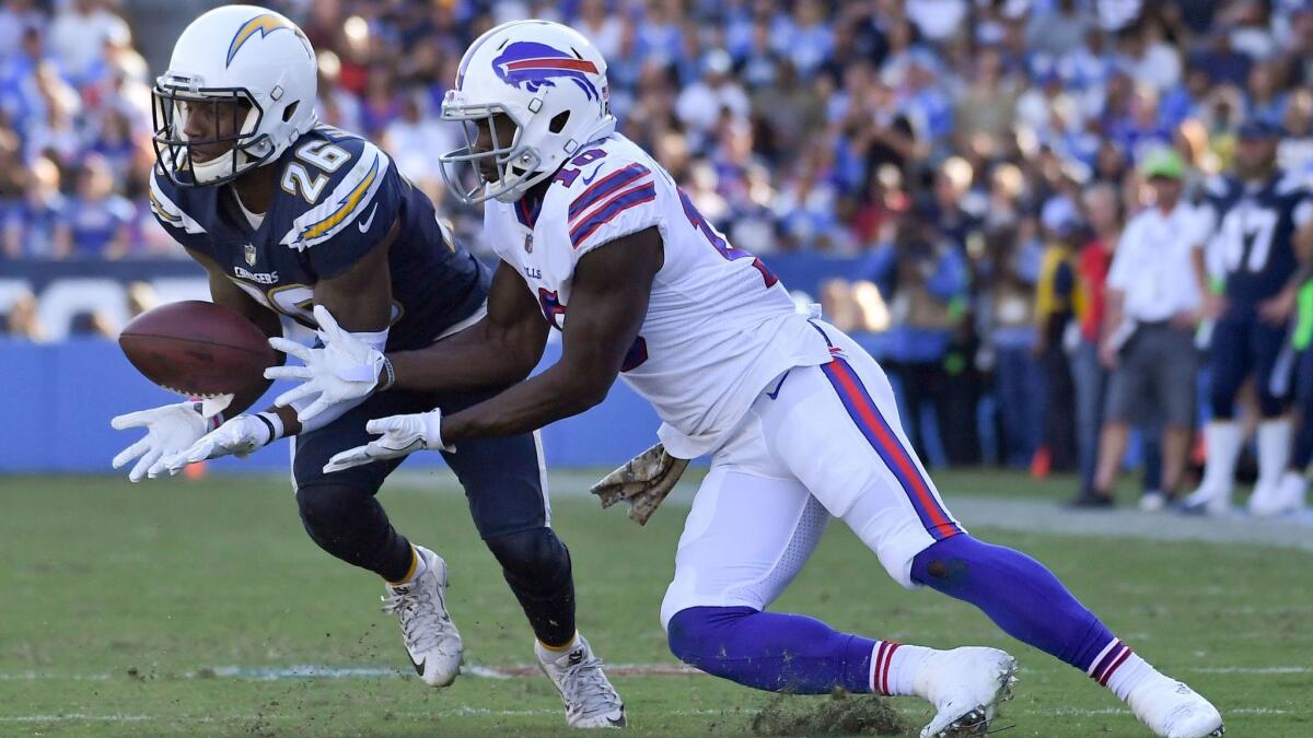 Chargers cornerback Casey Hayward (left) intercepts a pass intended for Buffalo Bills wide receiver Deonte Thompson during the first half of an NFL football game Nov. 19 in Carson.
