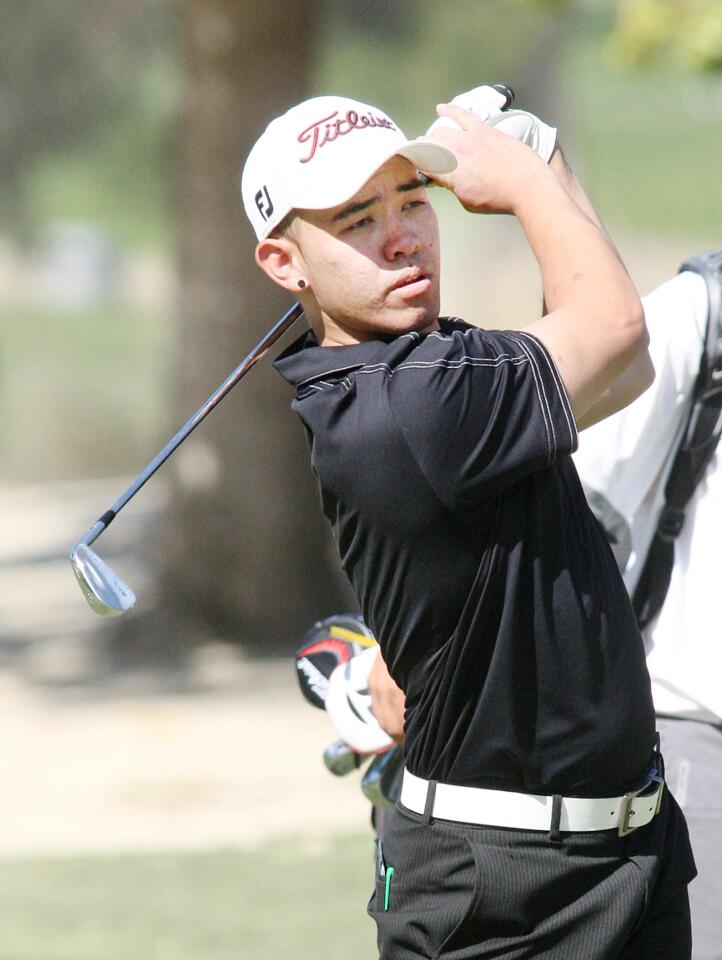 GCC's Vincent Lam hits a fairway shot on the ninth at Oakmont County Club in a Western State Conference golf match on Monday, April 14, 2014. Lam finished with in a tie for the lead with a score of 77.