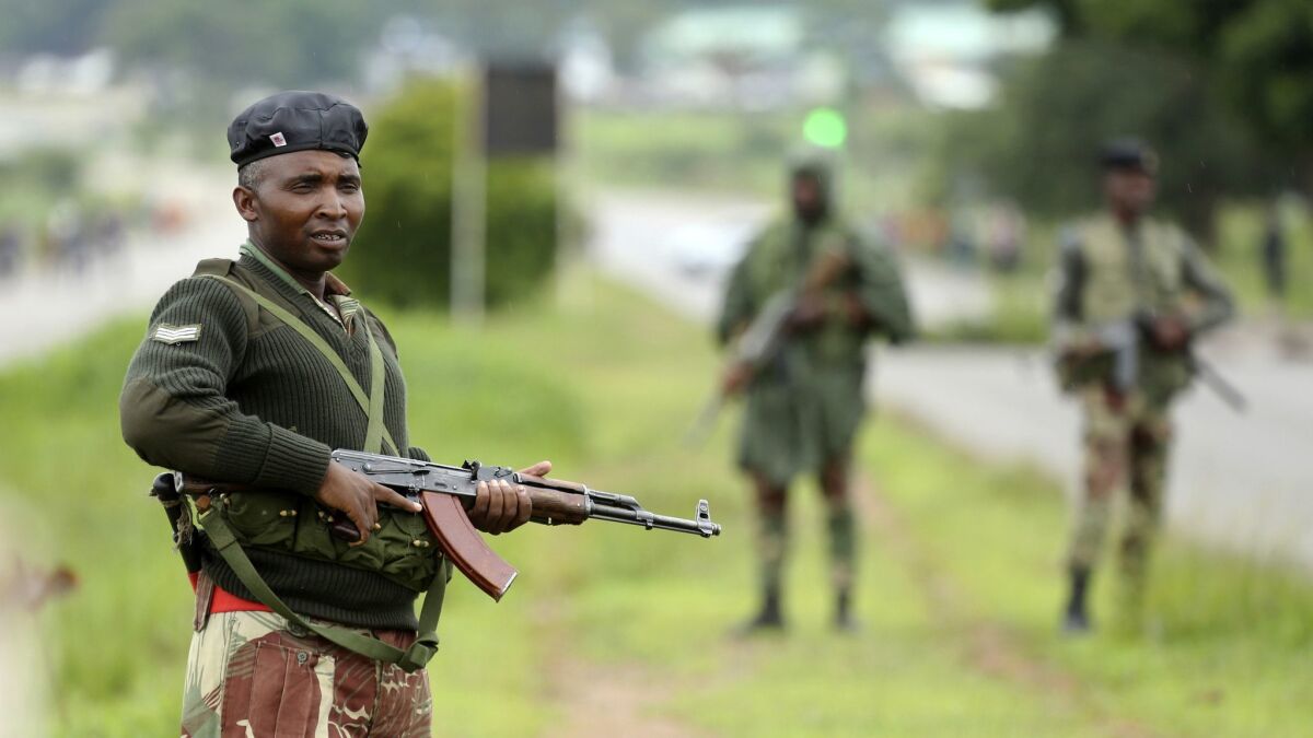 Soldiers patrol as protesters gather during a demonstration over the fuel price hikes in Zimbabwe.
