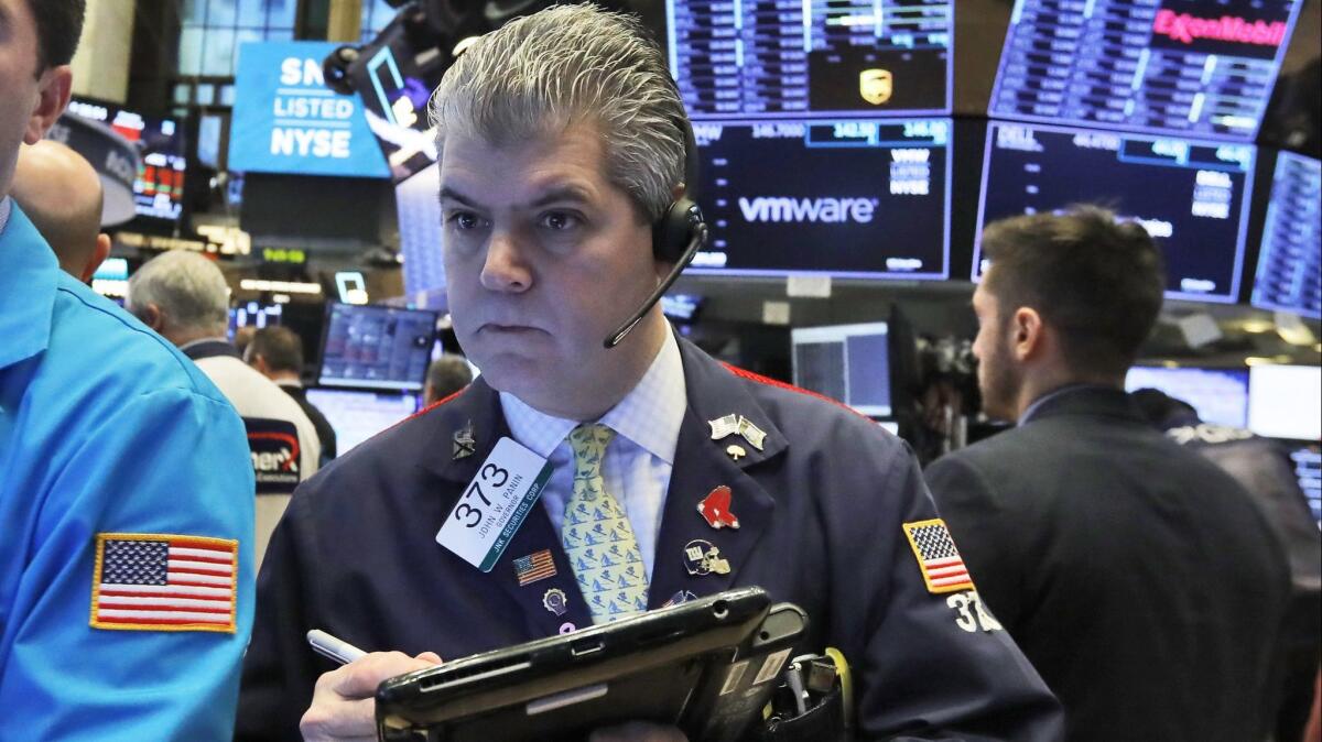 Trader John Panin works on the floor of the New York Stock Exchange on Monday.