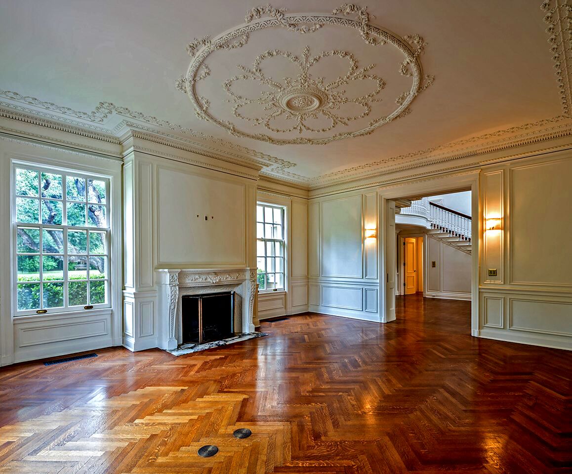 Ceiling medallions, columns, paneled walls, splashes of marble and parquet and herringbone floors are among details found throughout the four-story floor plan.