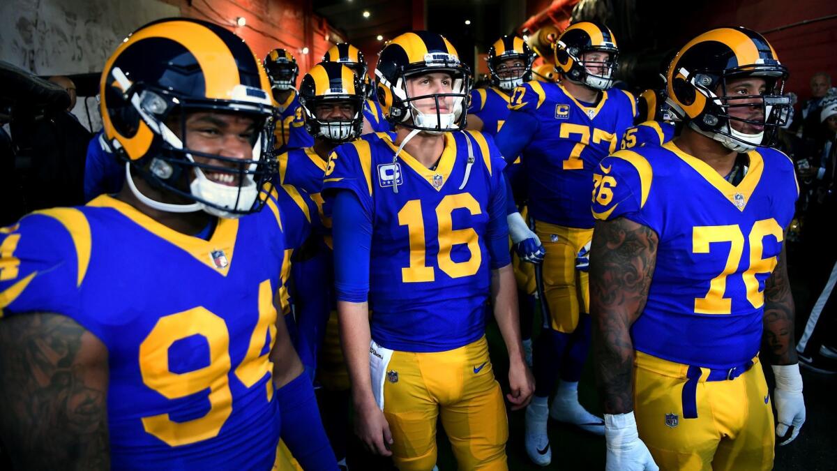 Rams quarterback Jared Goff, center, prepares to take the field with teammates at the Coliseum for their playoff opener against the Dallas Cowboys on Jan. 12.