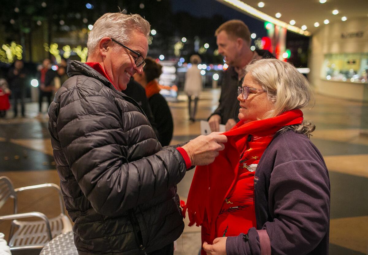 Todd Eckert wraps a scarf around Ruthanne Hogue before "A Christmas Carol" at the South Coast Repertory theater Friday.