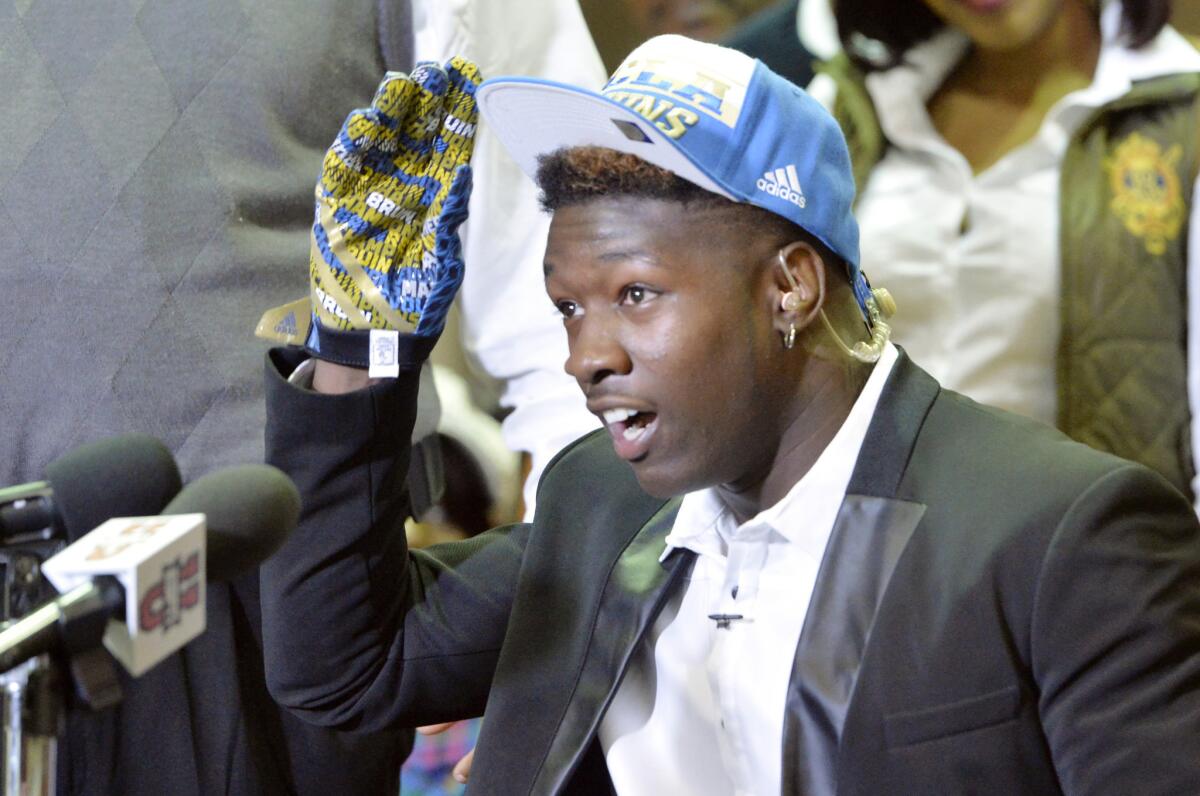 Macon County (Ga.) linebacker Roquan Smith puts on a UCLA hat during his televised national signing day decision to attend UCLA. Smith, however, did not send the Bruins a letter of intent and is keeping his options open.