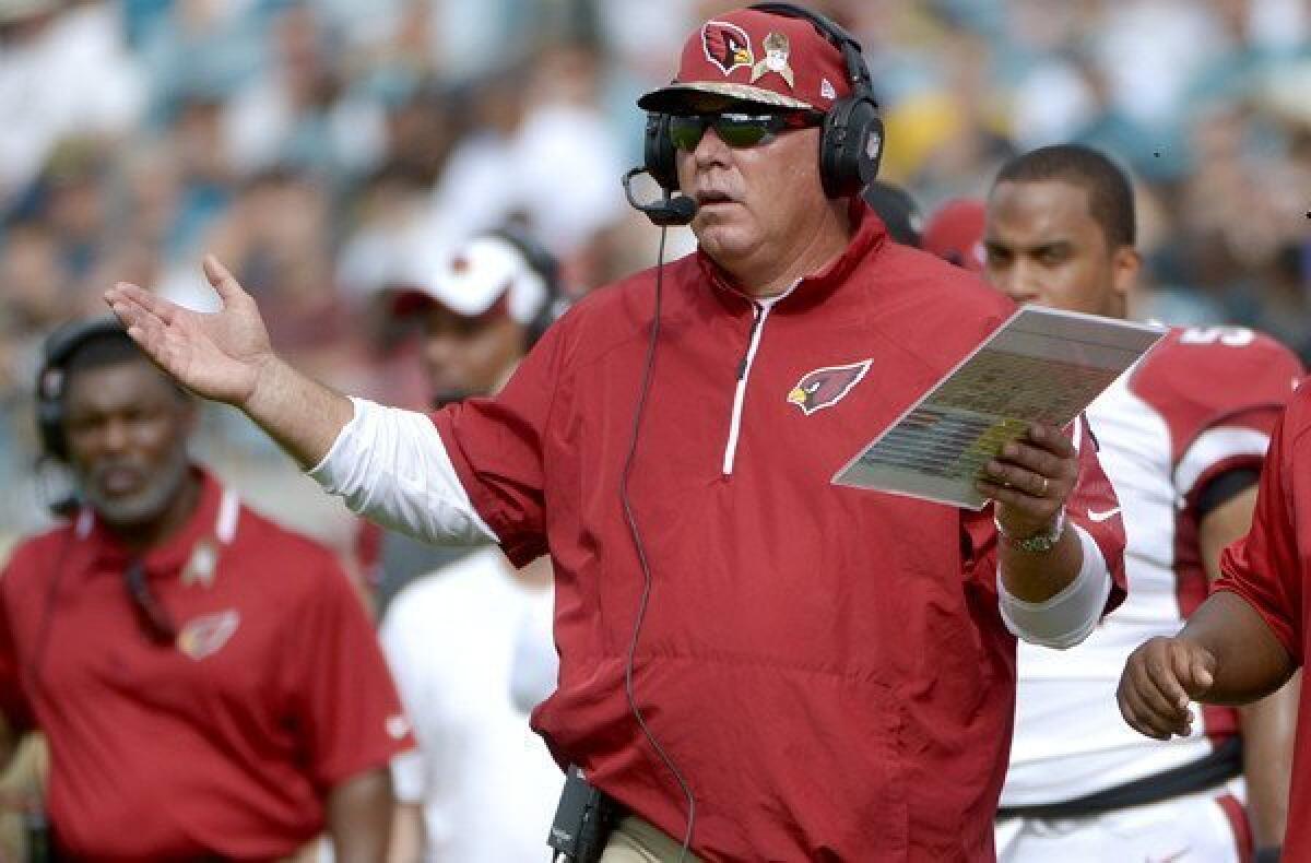 Arizona Cardinals Coach Bruce Arians questions a call by officials during the first half of a game against the Jaguars on Sunday in Jacksonville, Fla.