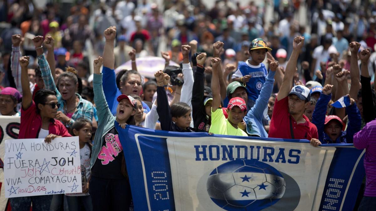 Migrants from Honduras shout slogans as they walk to the Basilica of Guadalupe, after arriving to a shelter in Mexico City on April 9.