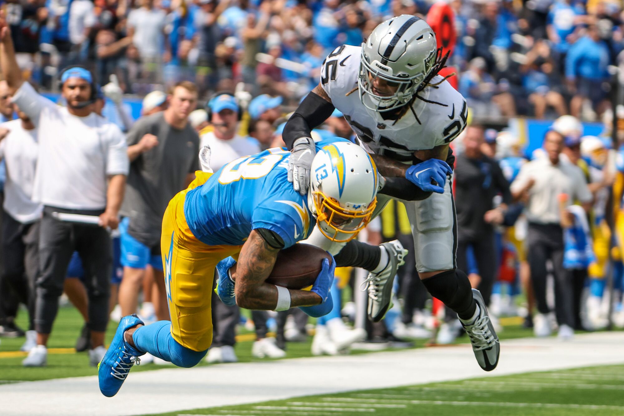 Chargers wide receiver Keenan Allen is tackled by Raiders safety Tre'von Moehrig in the second quarter.