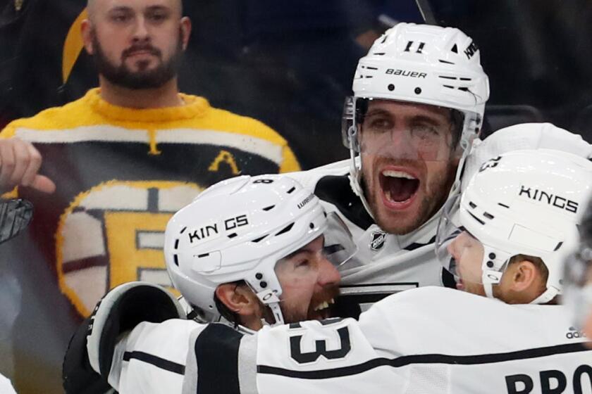 BOSTON, MASSACHUSETTS - DECEMBER 17: Anze Kopitar #11 of the Los Angeles Kings celebrates with Joakim Ryan #6, Drew Doughty #8, and Dustin Brown #23 after scoring a goal to defeat the Boston Bruins 4-3 in overtime at TD Garden on December 17, 2019 in Boston, Massachusetts. (Photo by Maddie Meyer/Getty Images)