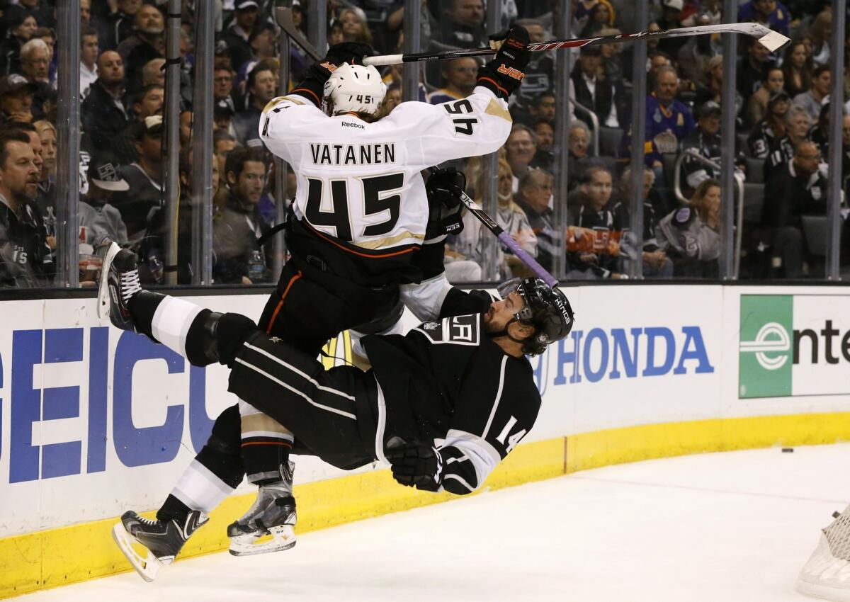 Ducks defenseman Sami Vatanen and Kings winger Justin Williams collide behind the goal while in pursuit of the puck in the first period.