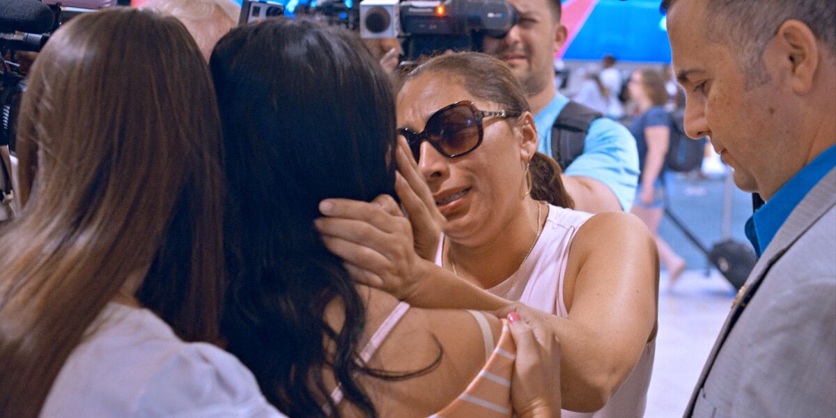 Alejandra Juarez says goodbye to her daughter Pamela at the airport in front of news crews as she boards a plane to Mexico. The image is from a new documentary series “Living Undocumented,” which highlights eight stories of people navigating a complex system. The show will be released Oct. 2.