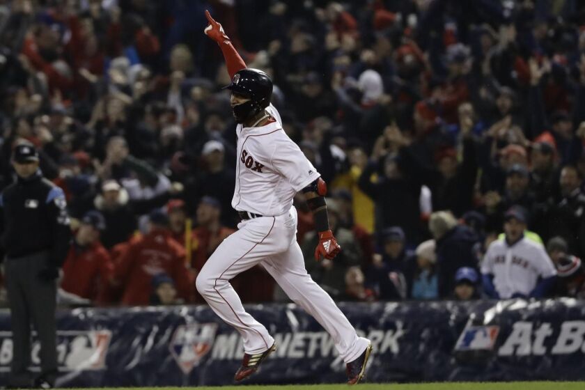 Boston Red Sox's Eduardo Nunez reacts after hitting a three-run home run during the seventh inning of Game 1 of the World Series baseball game against the Los Angeles Dodgers Tuesday, Oct. 23, 2018, in Boston. (AP Photo/Matt Slocum)